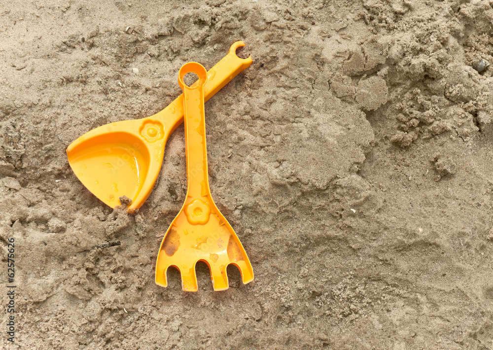 Child's scoop and raker on the sand Child's scoop and raker on the sand