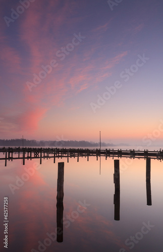 Tranquil and colorful sunrise at a small marina.