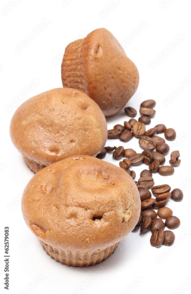 Fresh baked muffins and coffee grains on white background