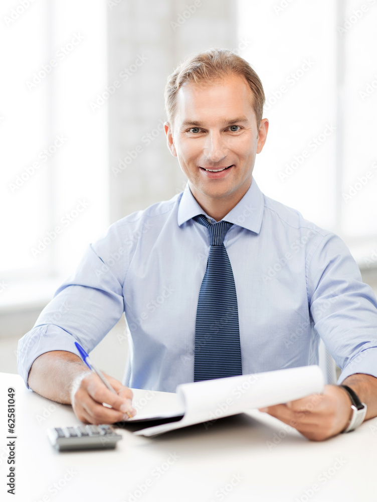 businessman with notebook and calculator businessman with notebook and calculator