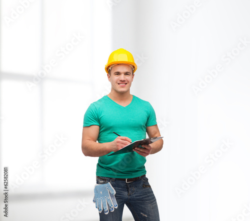 smiling man in helmet with clipboard photo