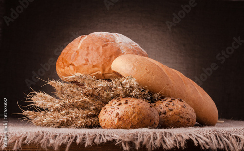 Loaf of bread and wheat ears still life