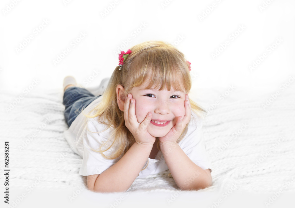 sweet little blonde girl lying happy on bed sweet little blonde girl lying happy on bed