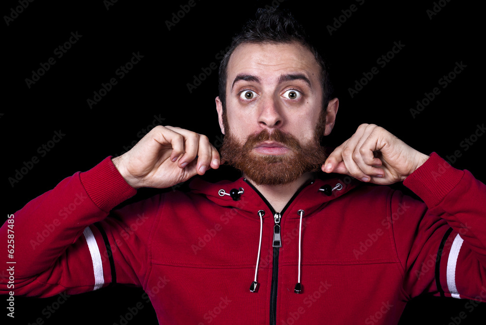 Obraz premium young guy pulls his long red beard