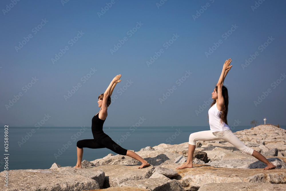 Beautiful young woman practicing yoga on the beach Beautiful young woman practicing yoga on the beach