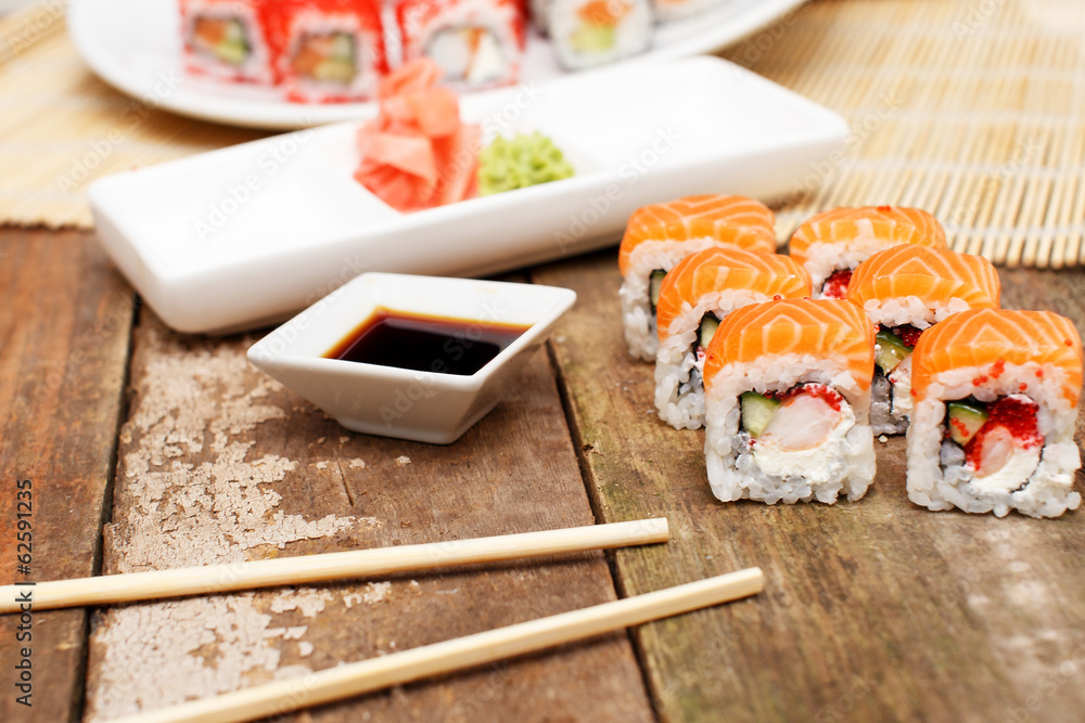 Salmon sushi set with soy sauce and chopsticks Salmon sushi set with soy sauce and chopsticks