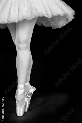 A ballet dancer standing on toes while dancing artistic conversi photo