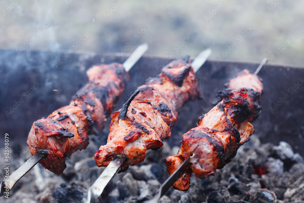 slices of meat prepare on fire with smoke slices of meat prepare on fire with smoke