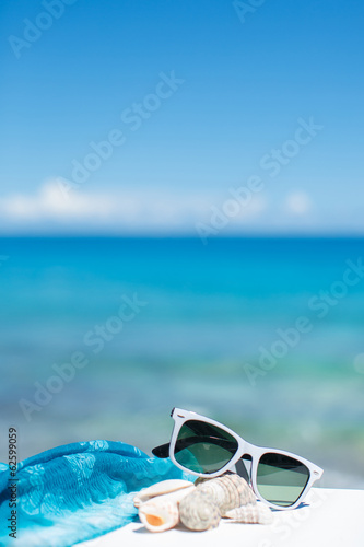summer concept with sunglasses and seashell on sand © GTeam