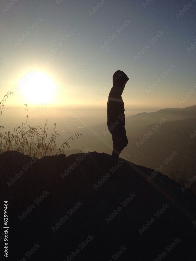 human silhouette on top of mountain