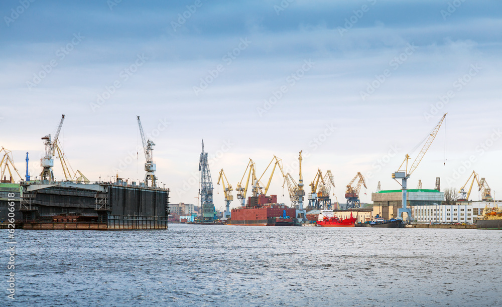 Industrial panorama with cranes and docks. Big Neva River