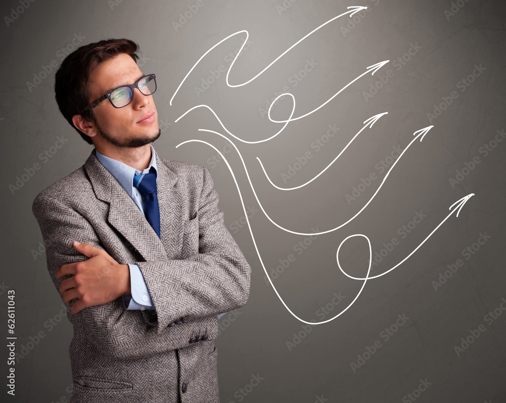 Attractive man looking at multiple curly arrows Attractive man looking at multiple curly arrows
