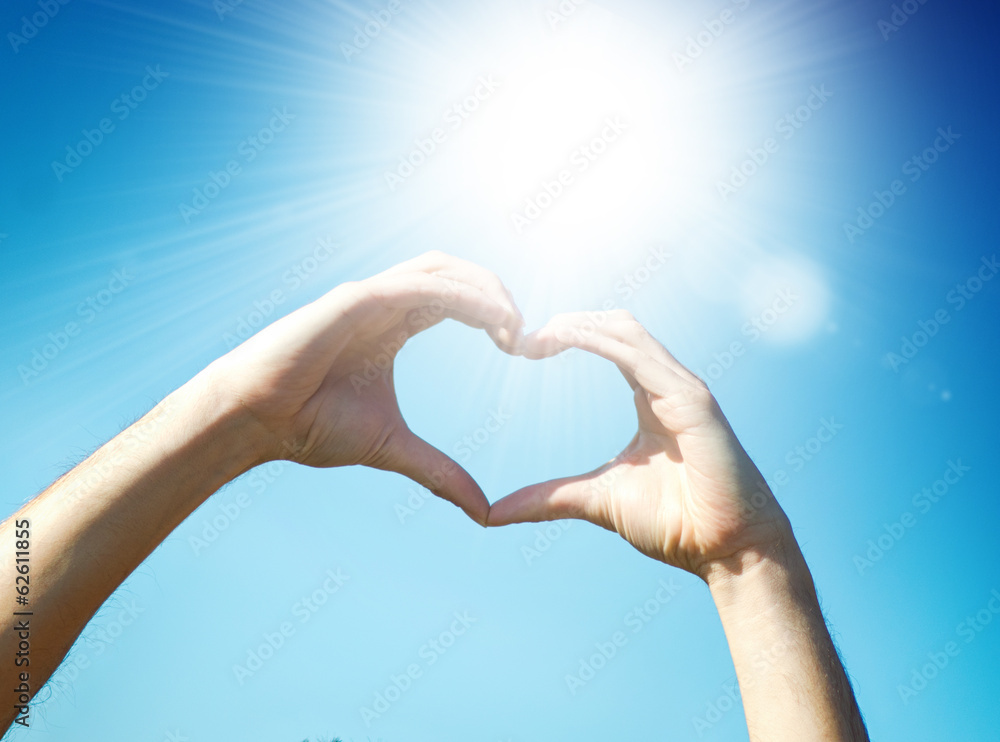 Hand heart shape against blue sky Hand heart shape against blue sky
