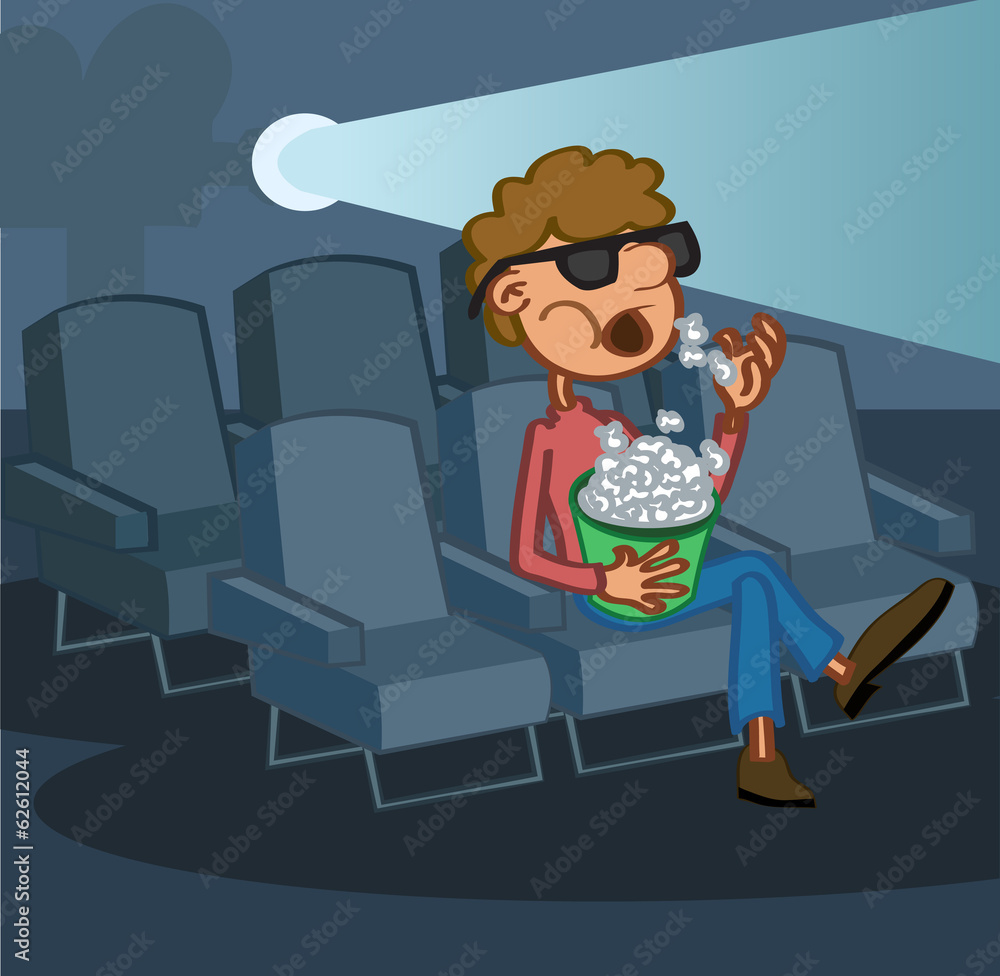 Boy eating popcorn watching movie in cinem