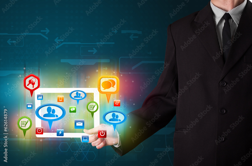Businessman presenting modern tablet with colorful social signs Businessman presenting modern tablet with colorful social signs