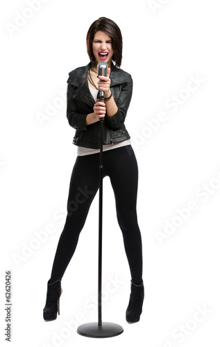 Full-length portrait of rock singer keeping static mic, isolated