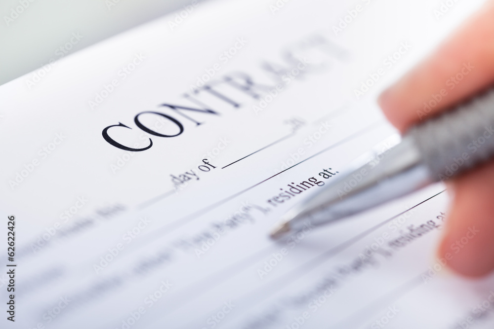 Hand With Pen On Contract Form Hand With Pen On Contract Form