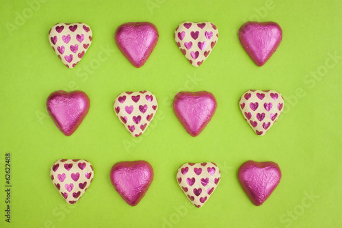 Collection of chocolate heart shapes wrapped in tin foil.