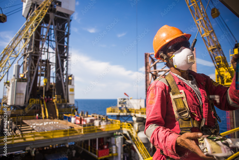 Man working at height with full PPE in oil rig in Thailand Stock Photo