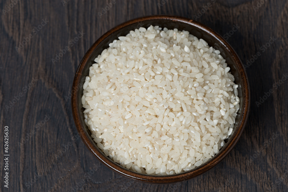 white rice in a bowl on dark background, top view white rice in a bowl on dark background, top view