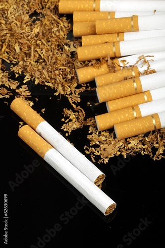 tobacco and cigarettes on the black background