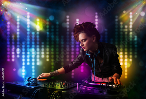 Dj girl playing songs in a disco with light show