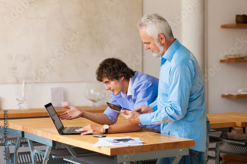 business man working on laptop with Colleges indoor