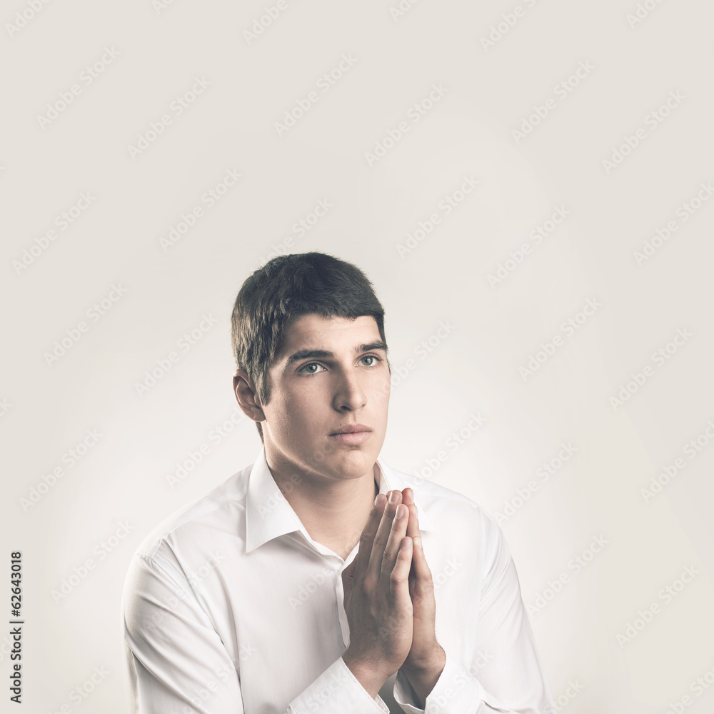 Prayer. The young man is religious. Portrait young man praying. Prayer. The young man is religious. Portrait young man praying.