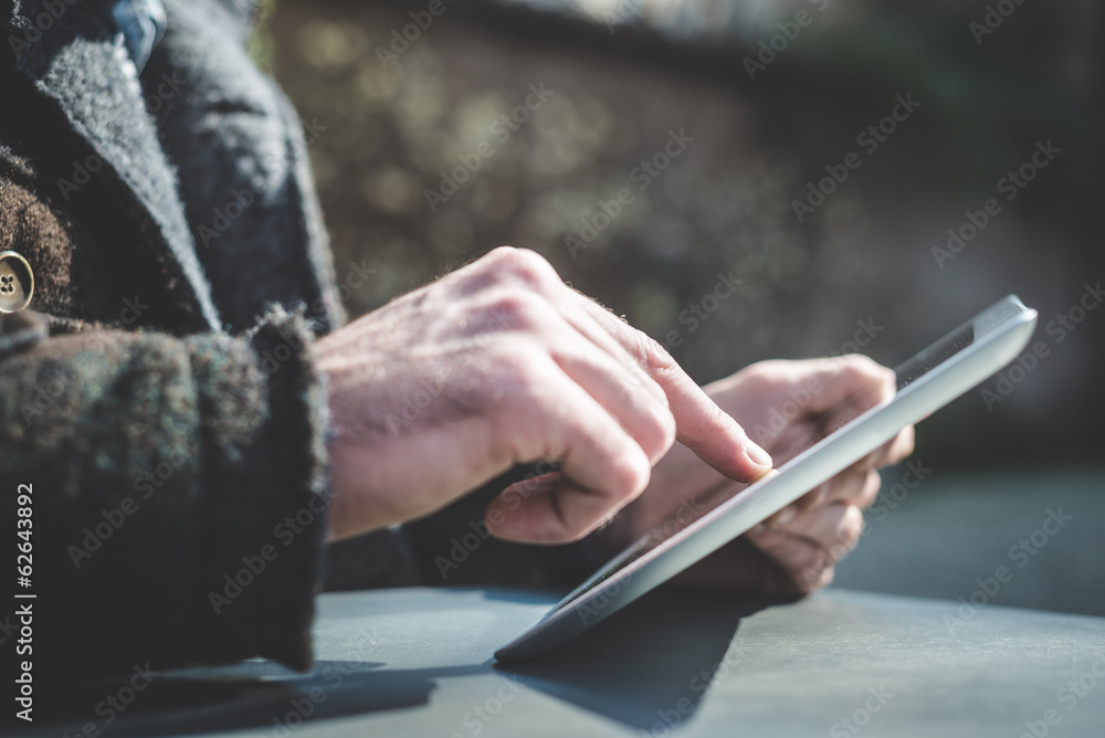 close up of hands man using tablet