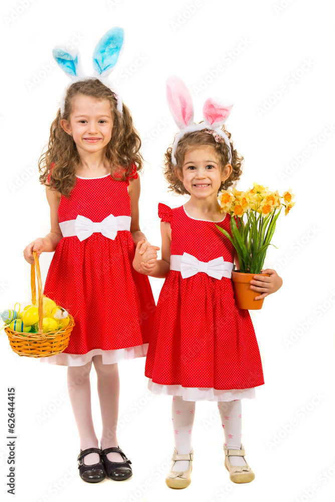 Fototapeta premium Happy sisters with bunny ears and easter eggs