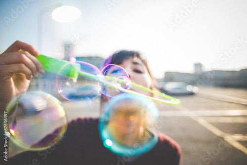 young beautiful hipster woman bubble blower photo