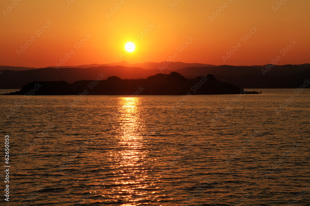Sunset over a greek island in the Mediterranean sea