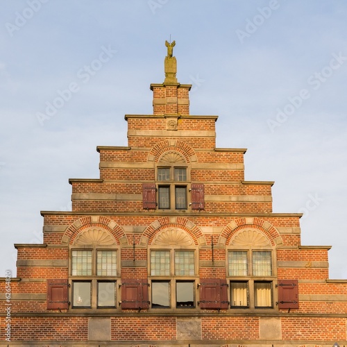 Old historic gable house during golden hour photo