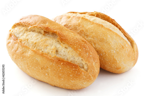 Two crusty mini baguettes on white surface