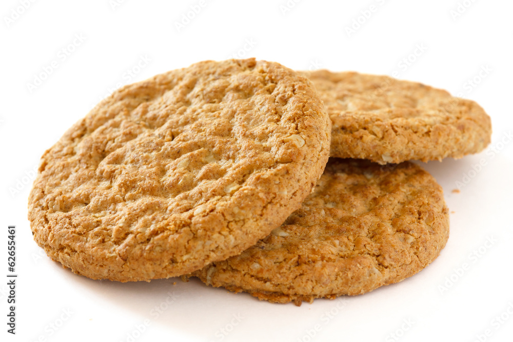 Detail of three crispy golden oat biscuits on white Detail of three crispy golden oat biscuits on white