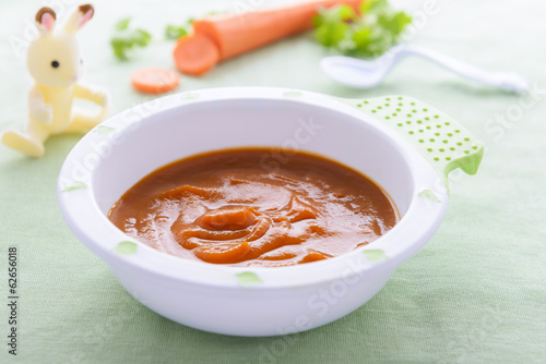 Baby nutrituion - carrot puree in white plate photo