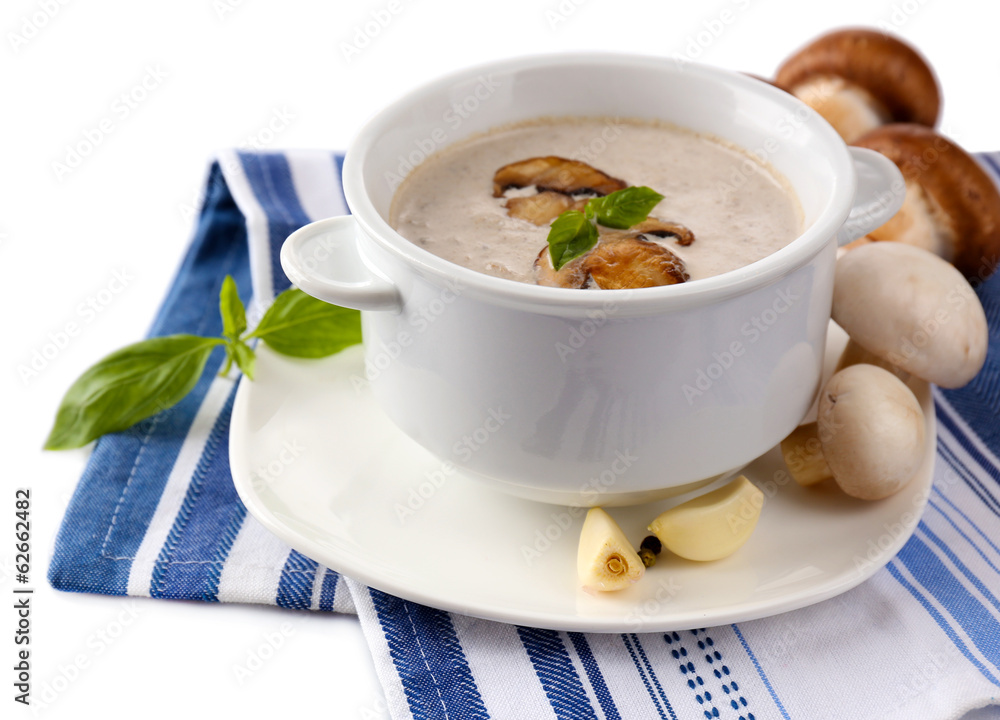 Mushroom soup in white pot, on napkin, isolated on white Mushroom soup in white pot, on napkin, isolated on white