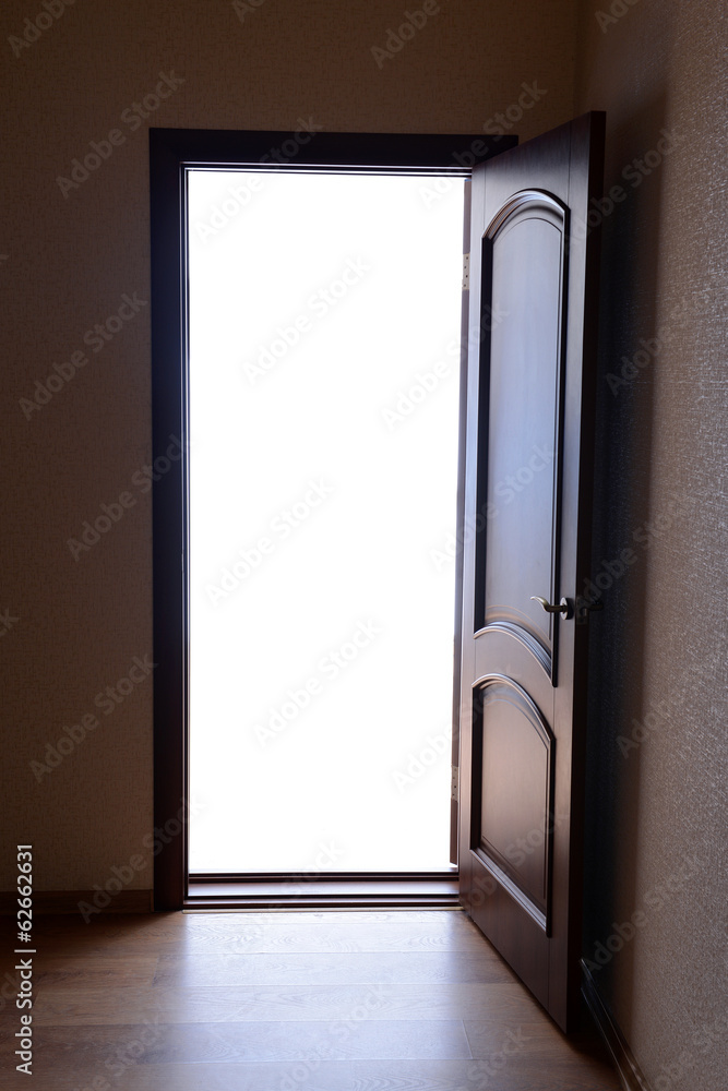 Fototapeta premium Open door with bright light outside