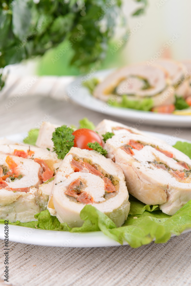 Delicious chicken roll on plate on table close-up Delicious chicken roll on plate on table close-up