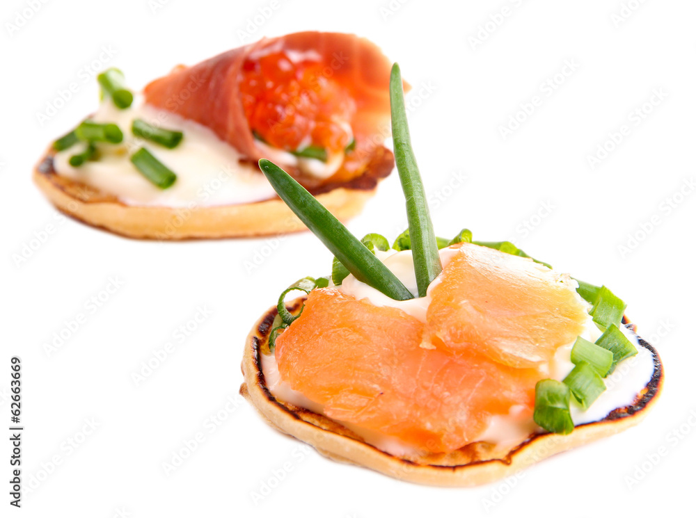 Pancakes with red caviar and salmon, isolated on white Pancakes with red caviar and salmon, isolated on white