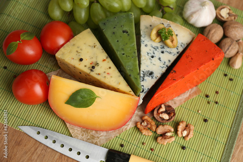 Different Italian cheese on wooden table photo