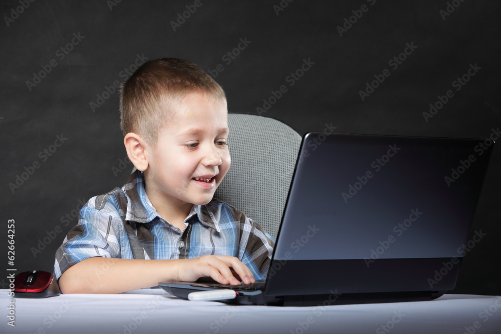 Computer addiction child with laptop notebook Computer addiction child with laptop notebook