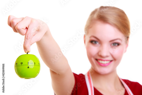 Happy housewife or chef in kitchen apron showing apple timer photo