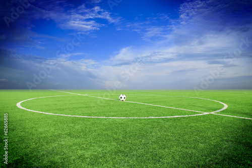 soccer ball on soccer field with sun set 