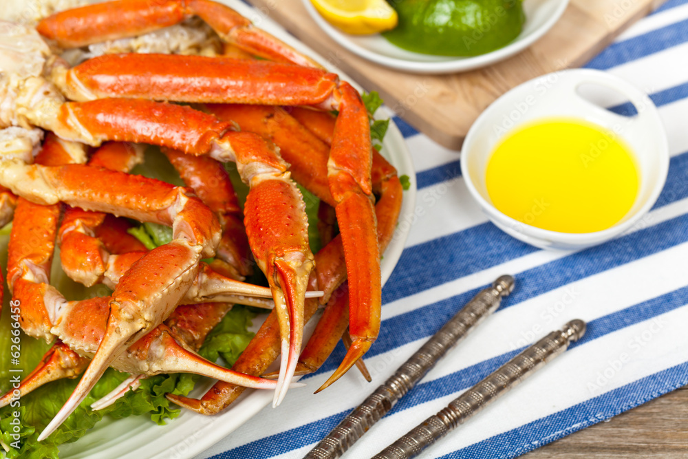Crab legs with fresh lemon slices and butter sauce Crab legs with fresh lemon slices and butter sauce