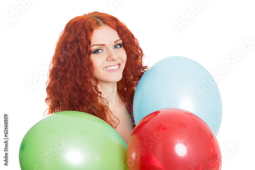 Joyful girl holding colorful balloons.