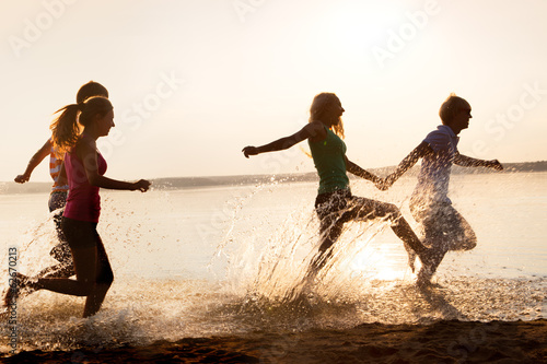 Group of happy teenagers at the beach
