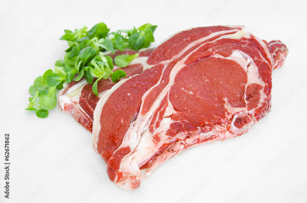 Pieces of crude meat, beef steak on white. Isolated Pieces of crude meat, beef steak on white. Isolated