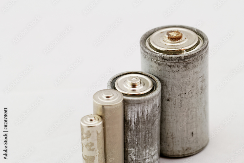Old batteries on white background Old batteries on white background