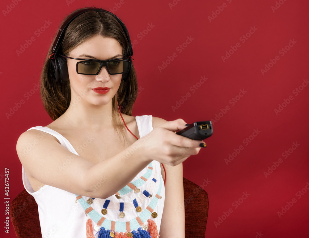 beautiful girl playing 3D video game isolated on red background